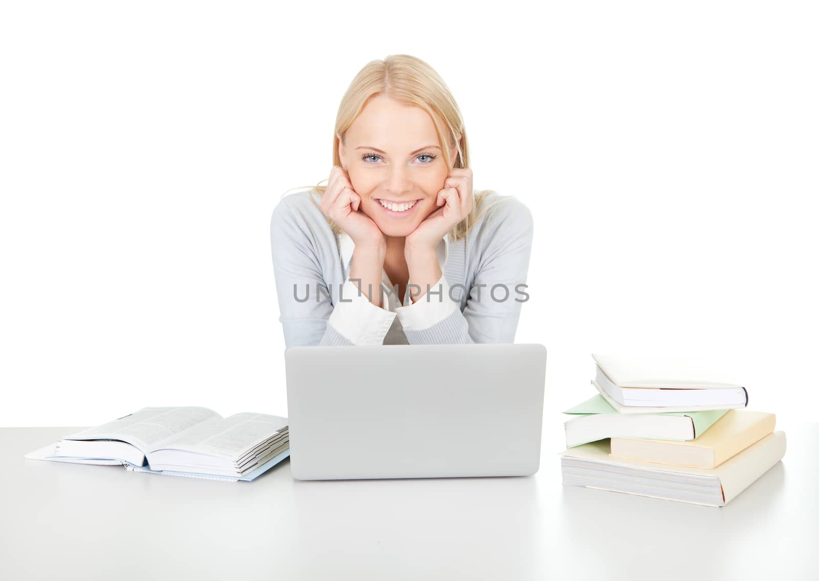 Beautiful student girl studying with laptop at the desk. Isolated on white