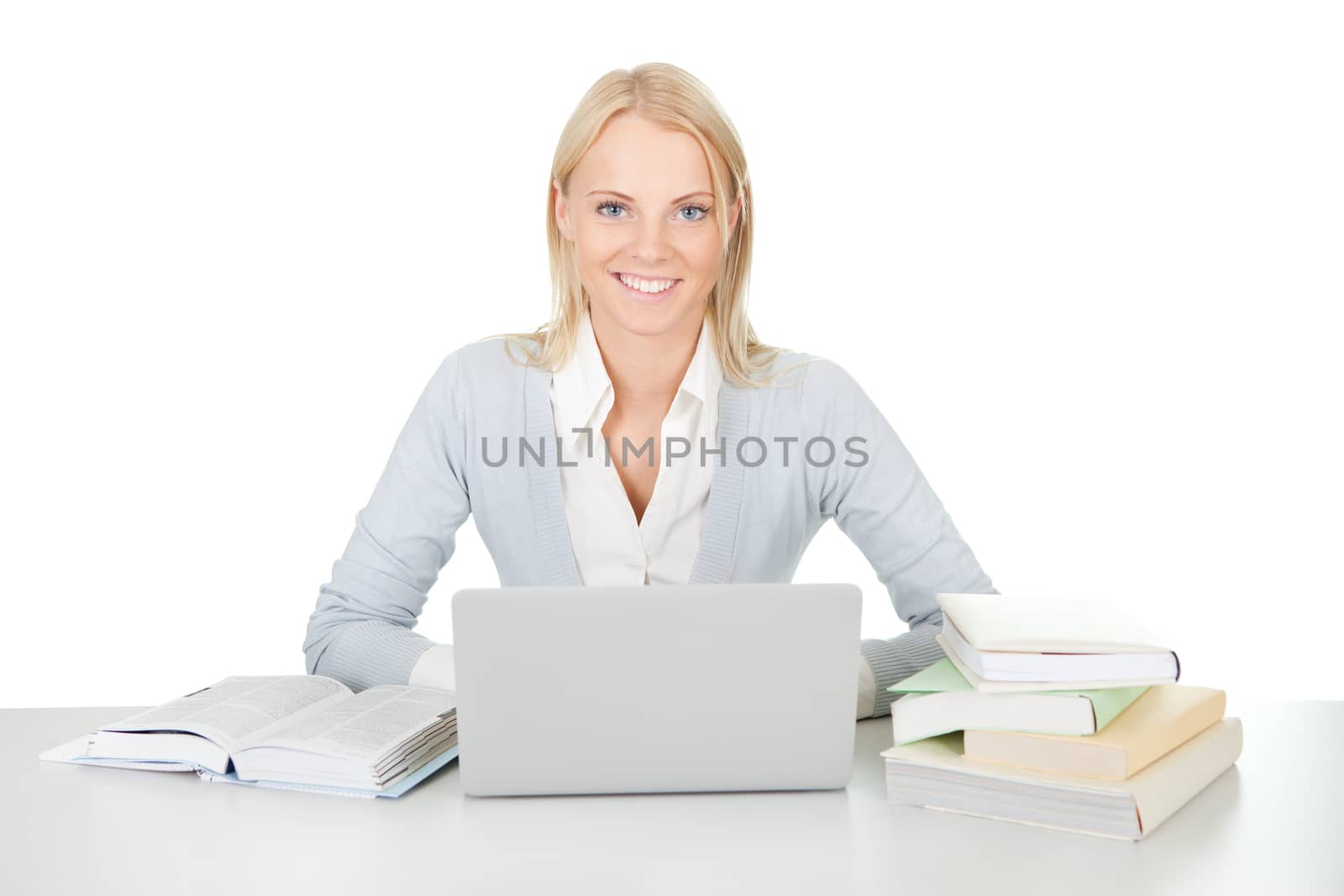 Beautiful student girl studying with laptop at the desk. Isolated on white