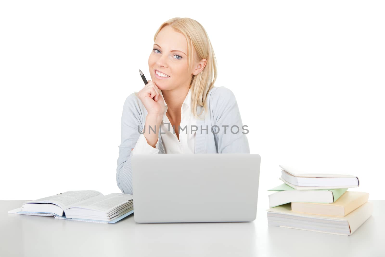 Beautiful student girl studying with laptop at the desk. Isolated on white