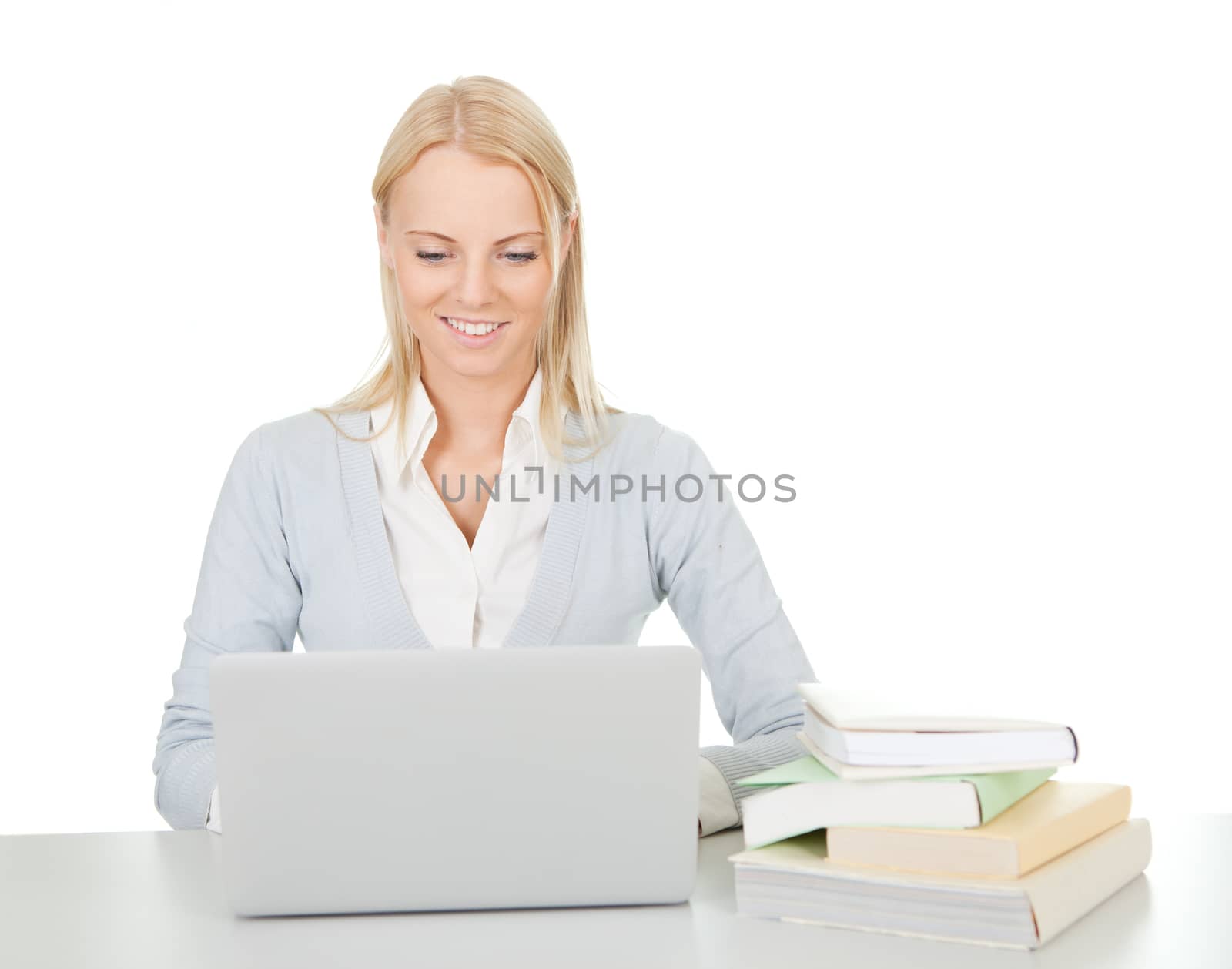 Beautiful student girl studying with laptop at the desk. Isolated on white