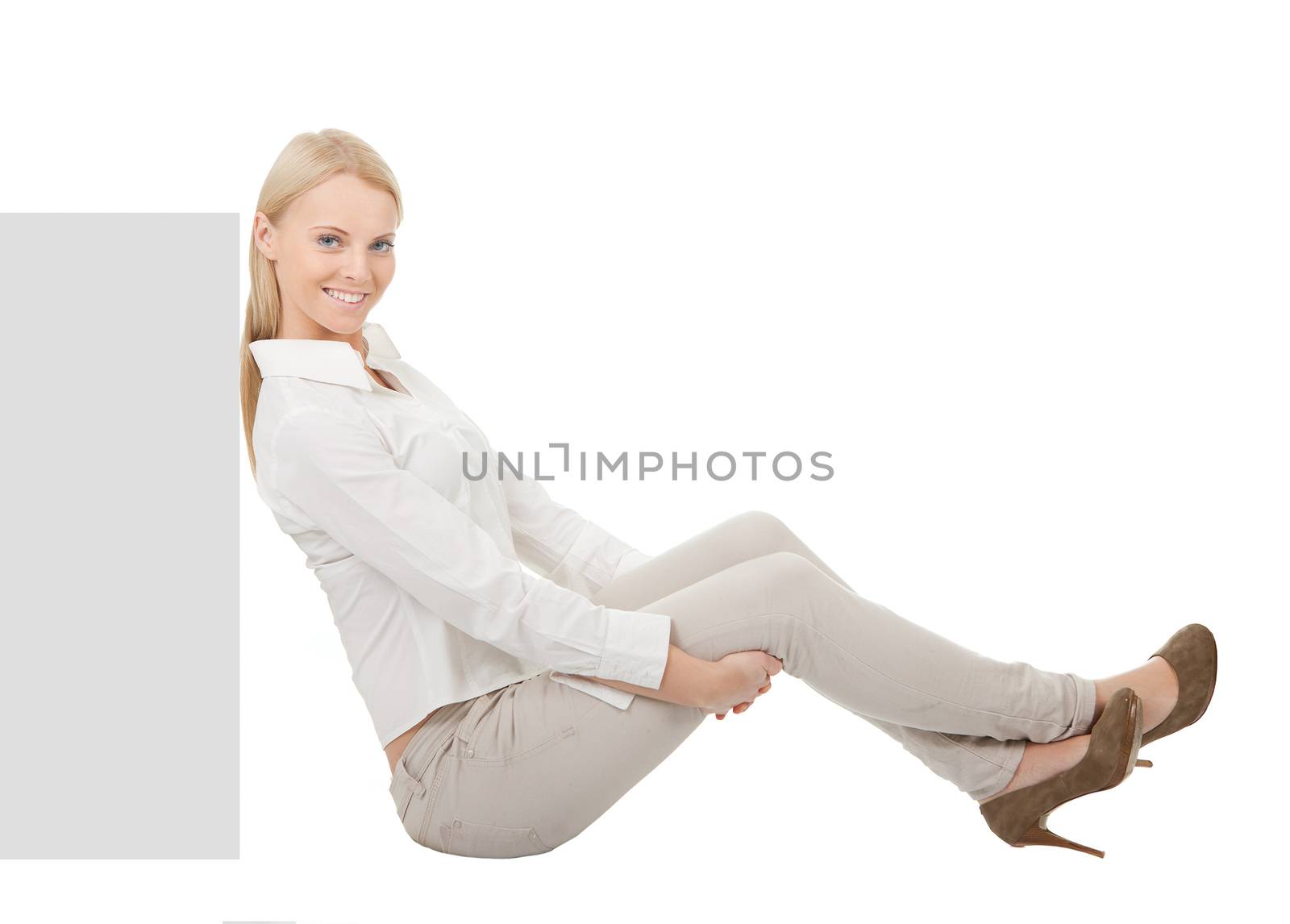 Businesswoman sitting next to copyspace. Isolated on white
