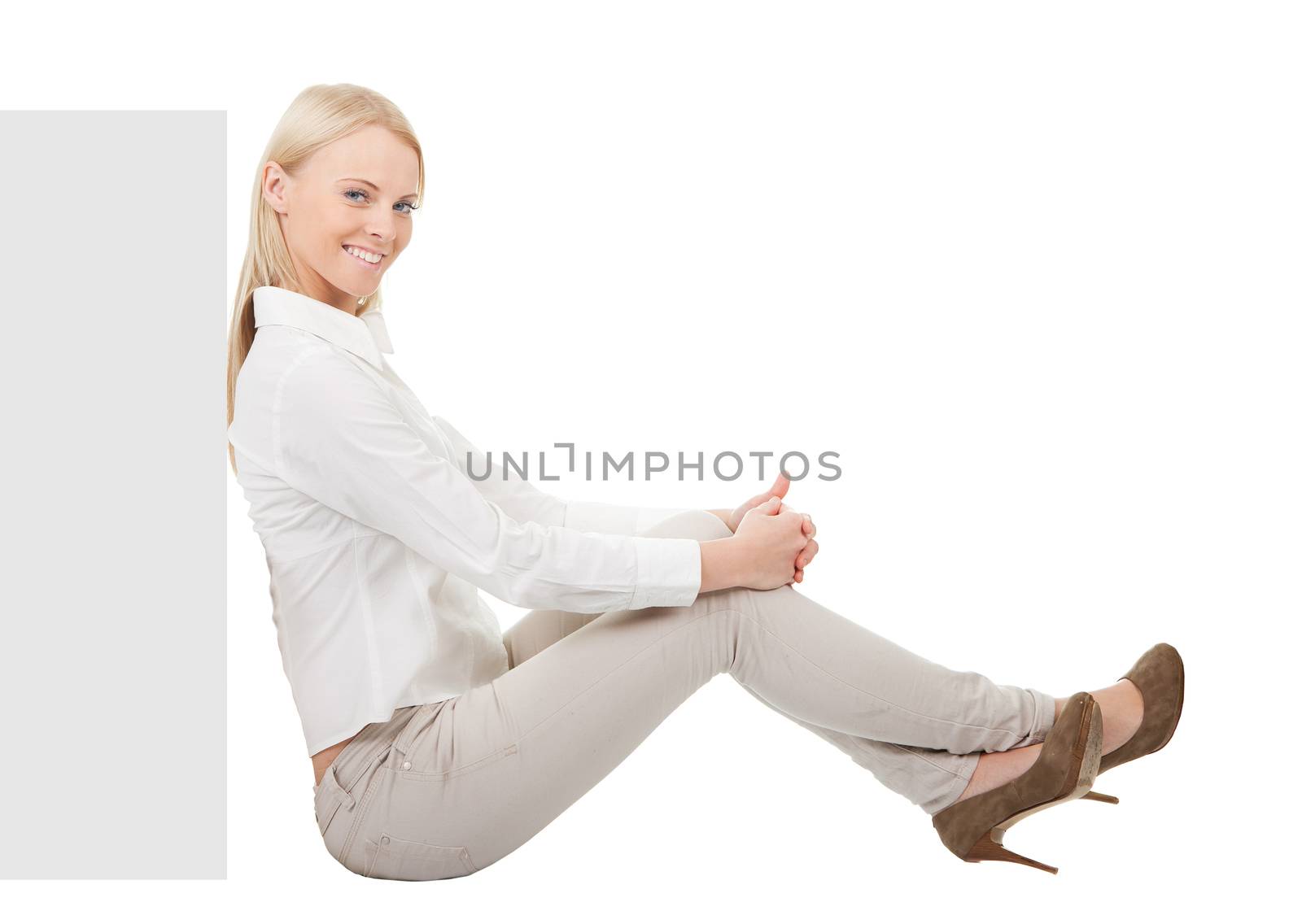 Businesswoman sitting next to copyspace. Isolated on white