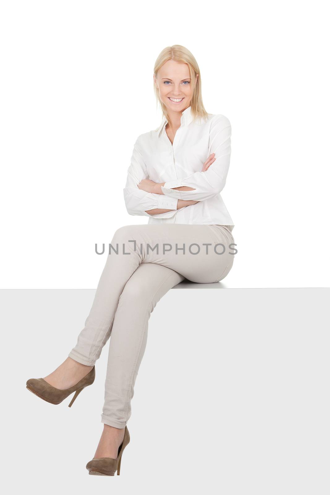 Businesswoman sitting on copyspace. Isolated on white