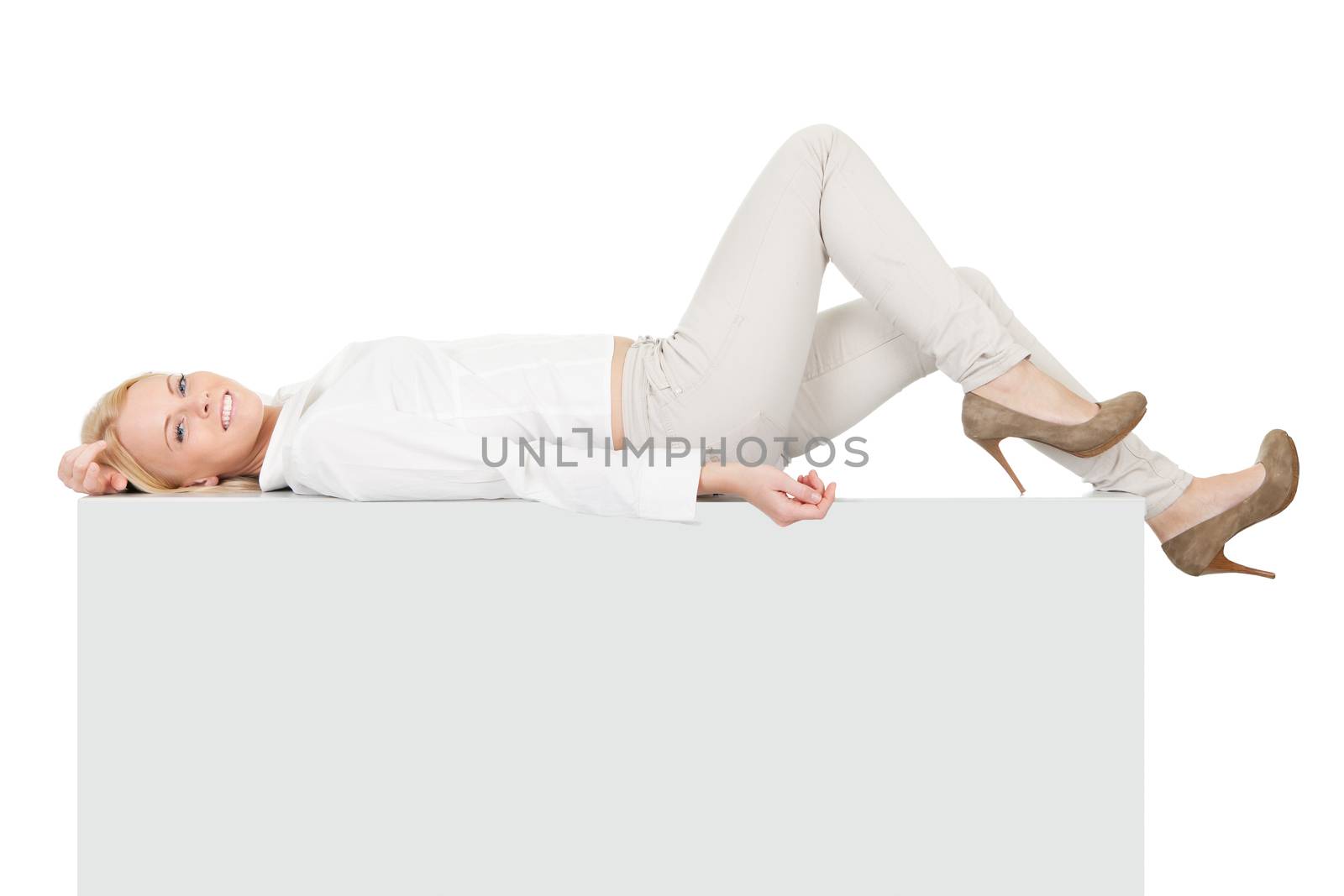 Businesswoman lying on copyspace. Isolated on white