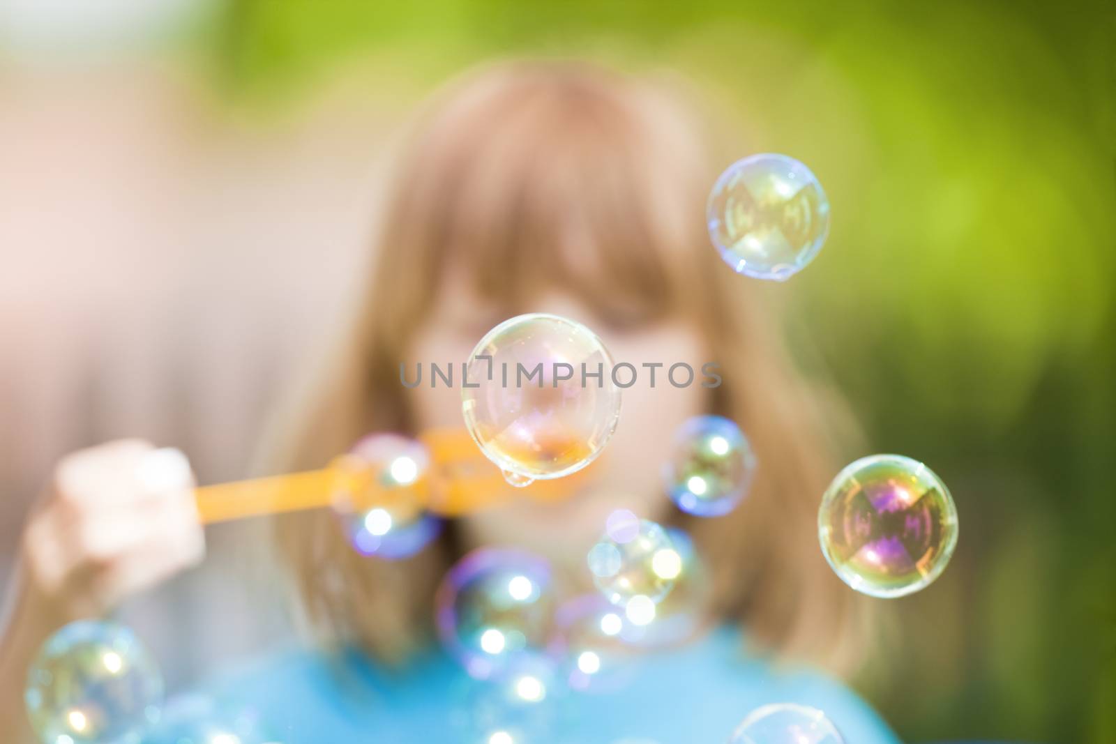 boy blowing bubbles by courtyardpix