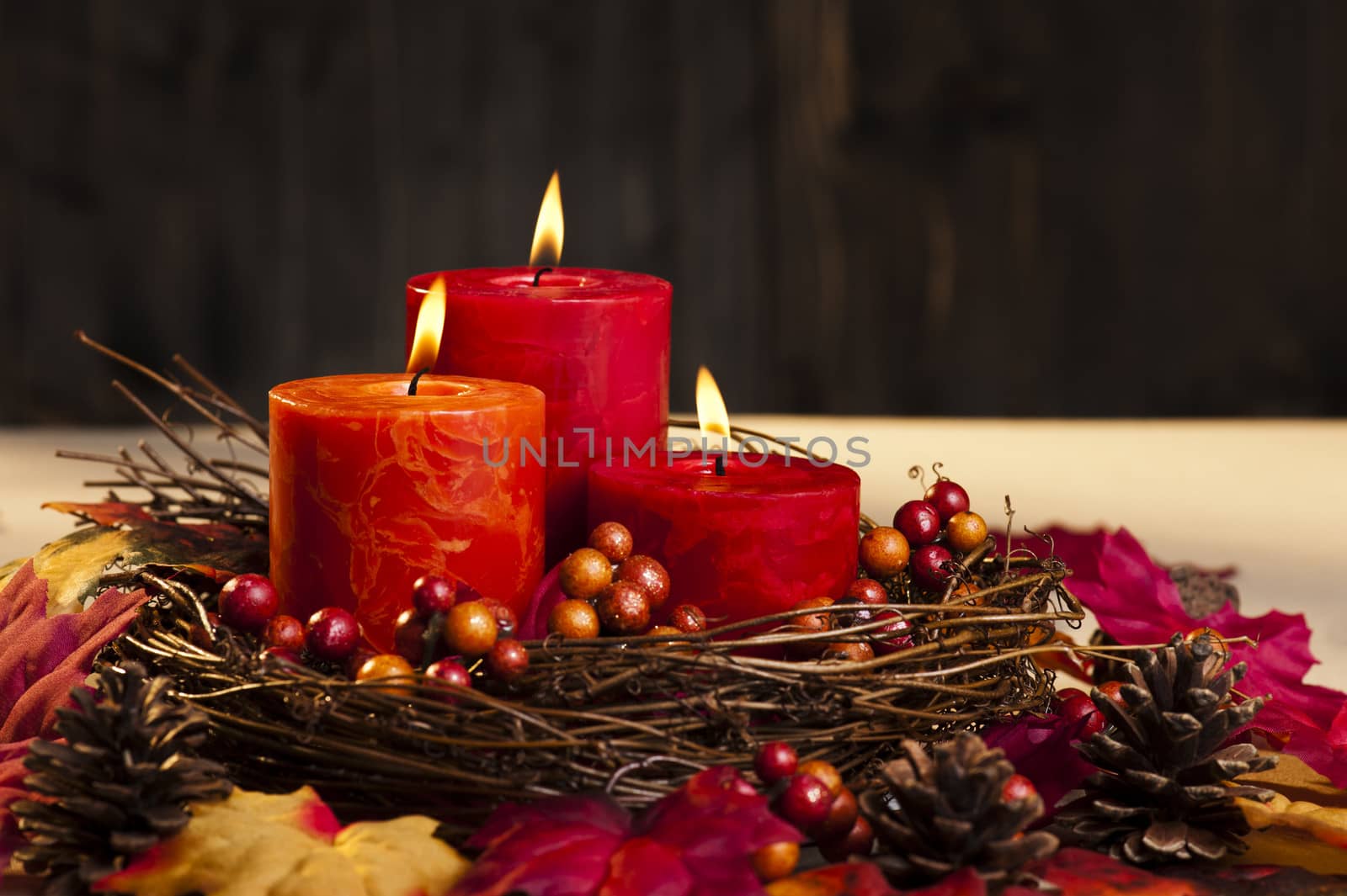 Candles in nice and beautiful colorful autumn leaves