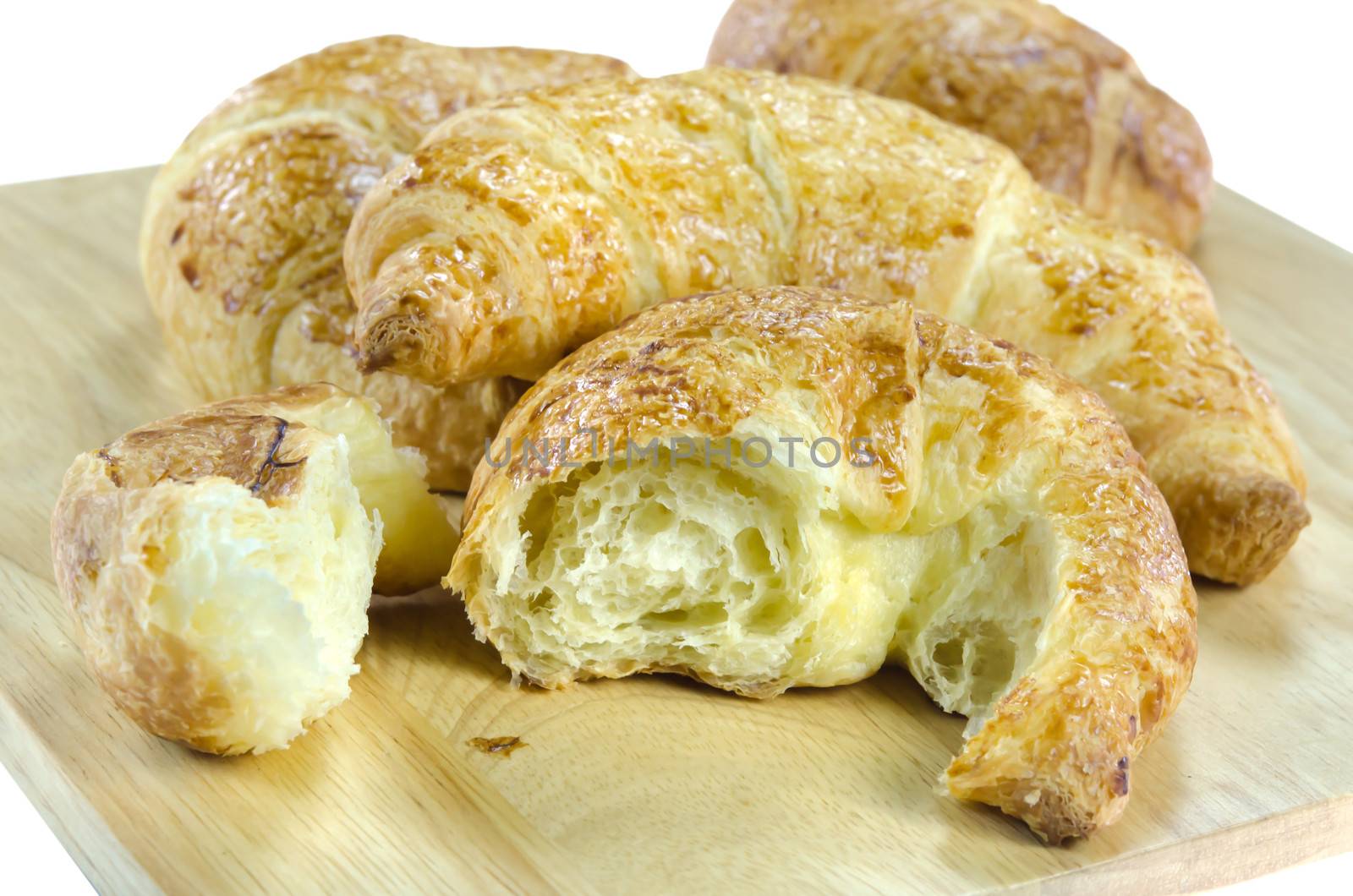 close up croissants on wooden plate ,  on white background