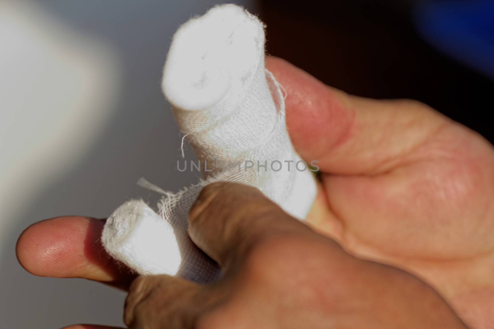 White medicine bandage on human injury hand finger by NagyDodo