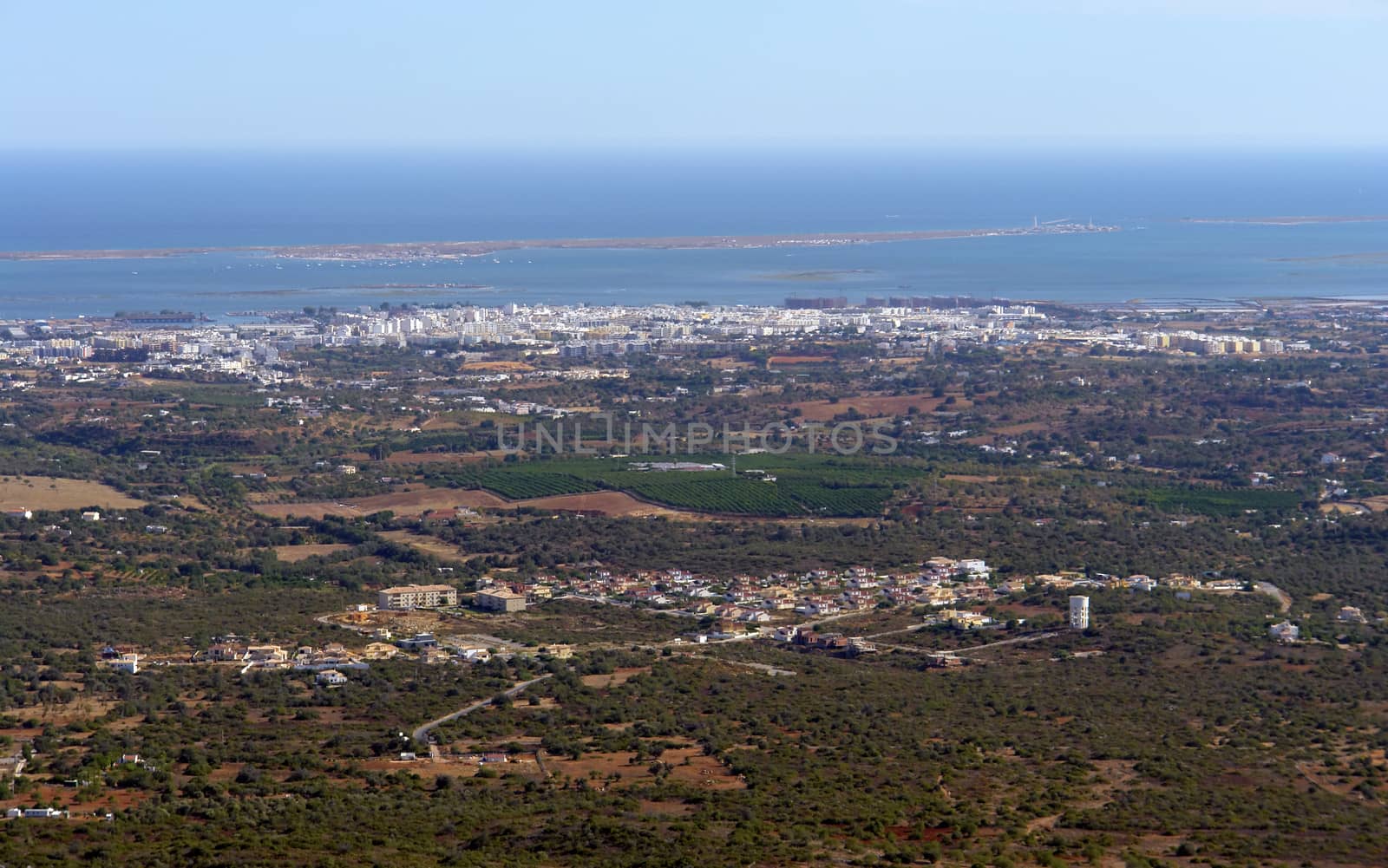 Ria Formosa ecosystem view from the hill, city of Olhao in the shoreline and "Farol" island in the background