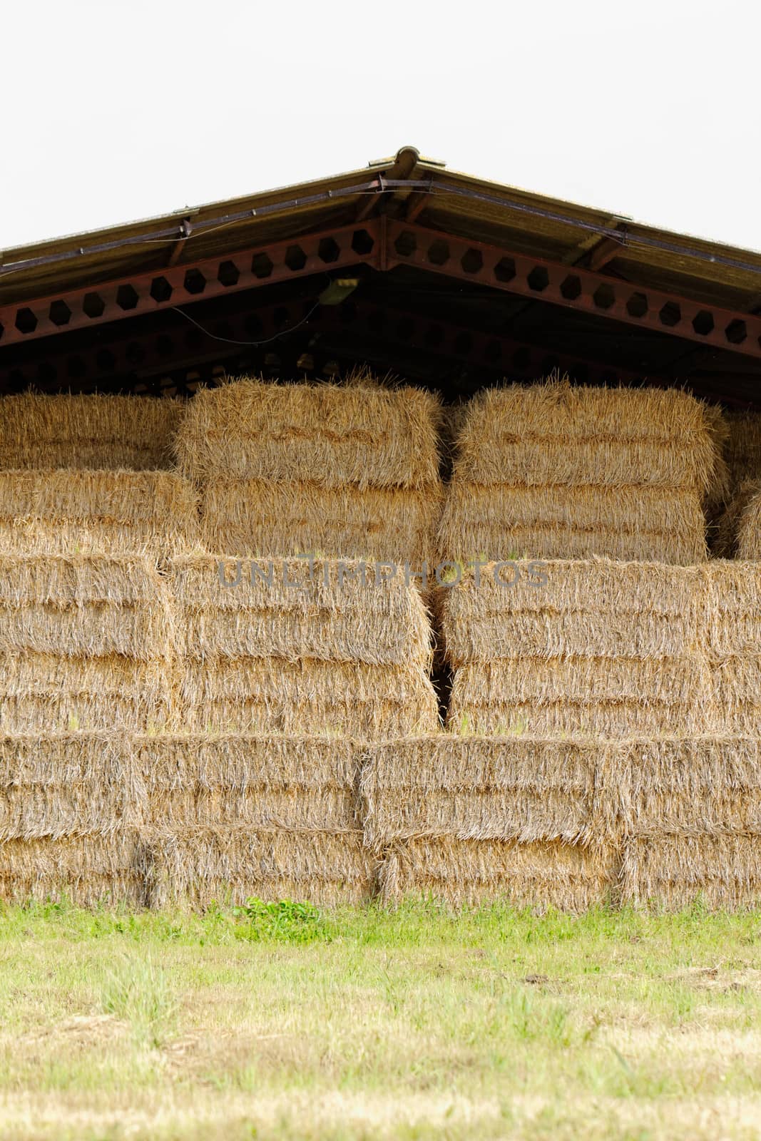 straw bales under the roof in the meadow