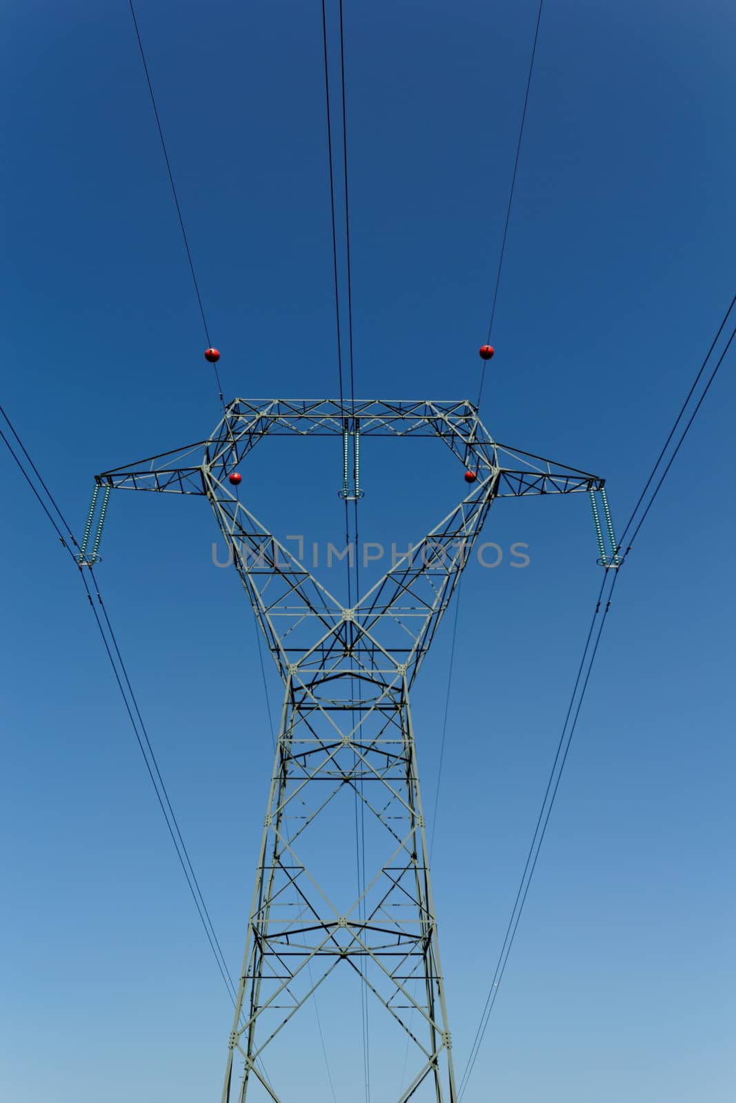 Detail of electricity pylon against blue sky 