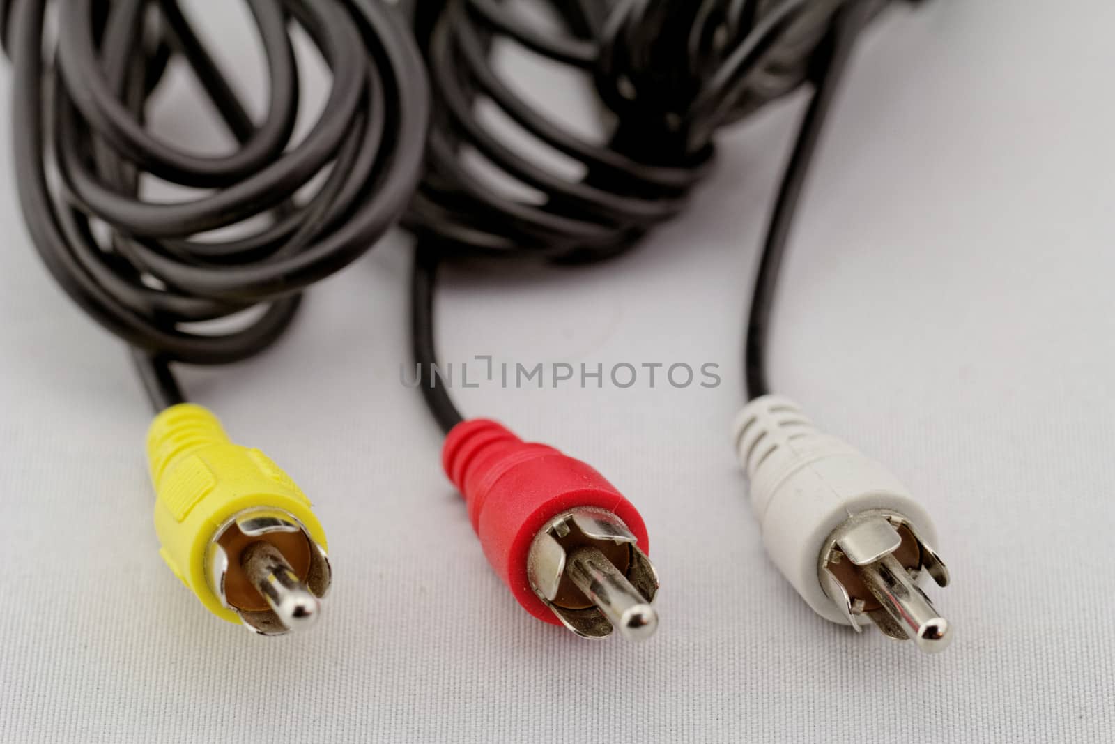 three audio (left - right) - video RCA cable and plug (red, white, yellow) on white background