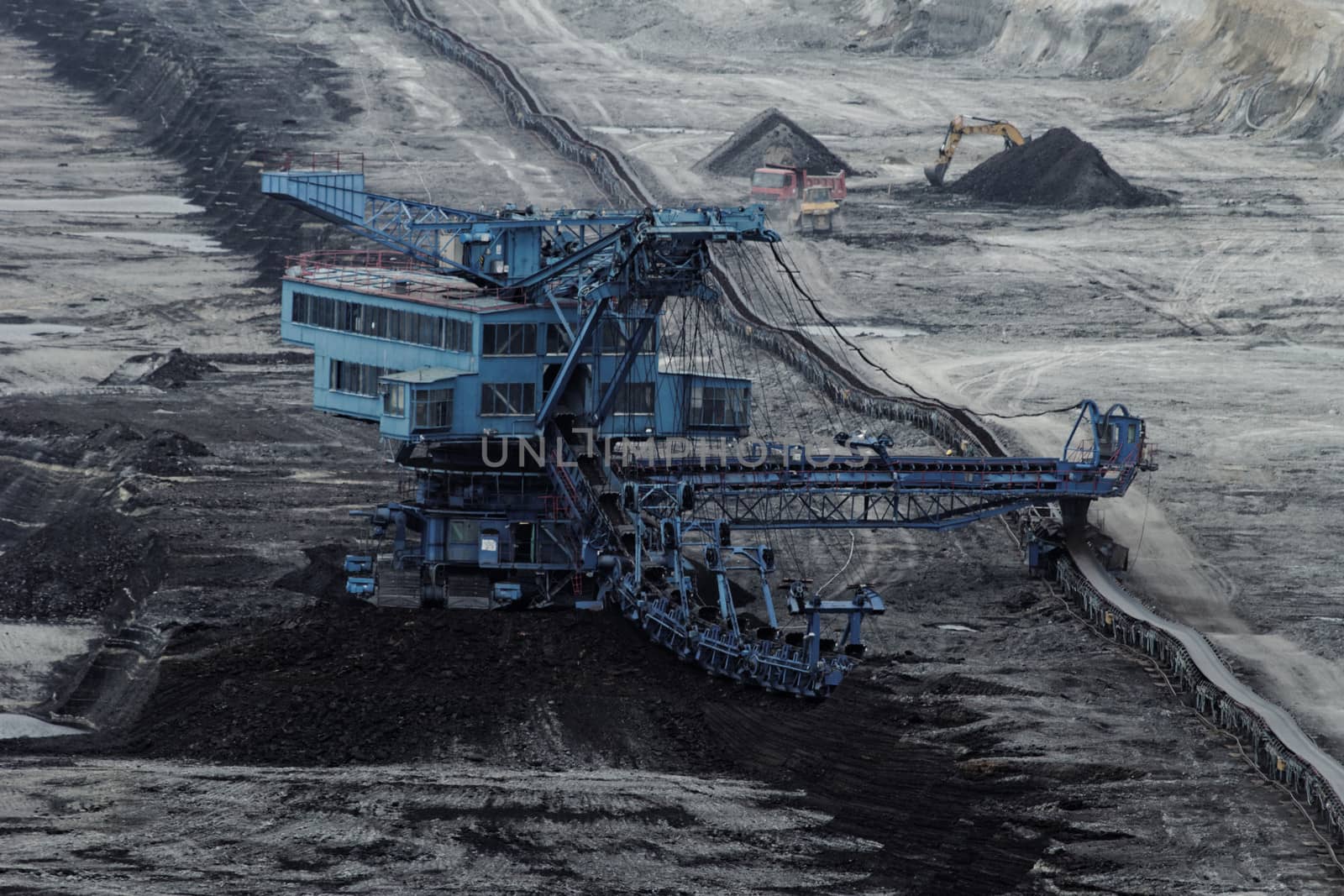 Coal mining in an open pit with huge industrial machine