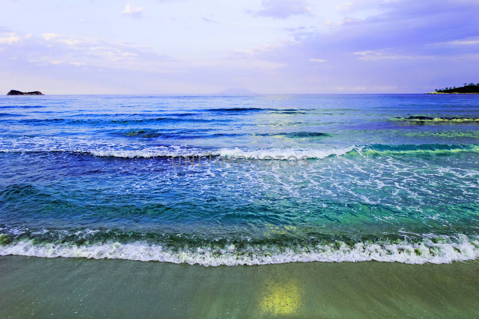 waves of sea on the sandy beach by NagyDodo