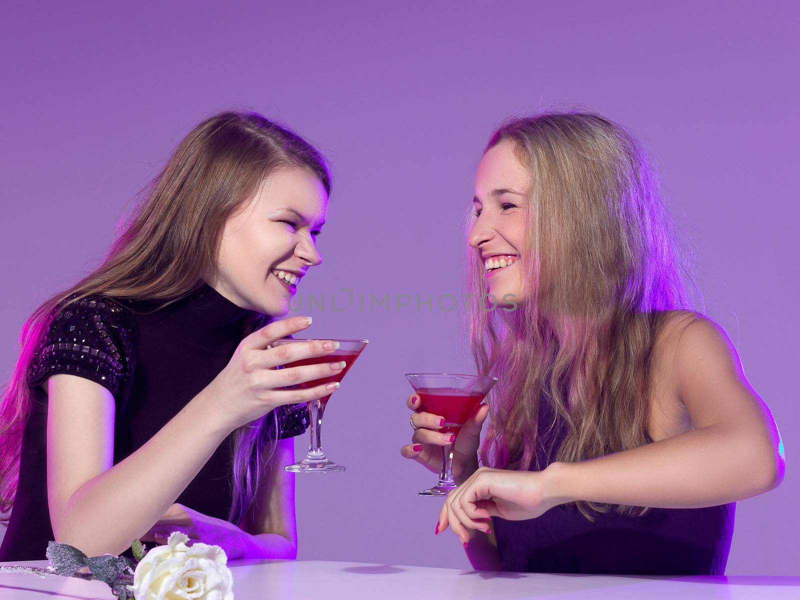 Female friends enjoying cocktails  in a nightclub by victosha