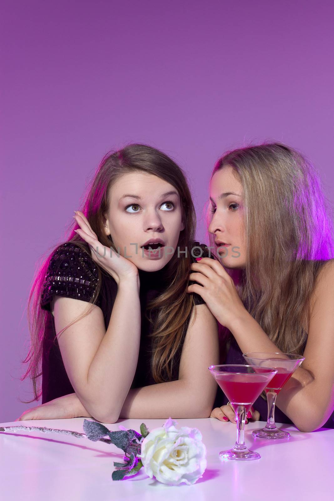 Female friends enjoying cocktails  in a nightclub by victosha