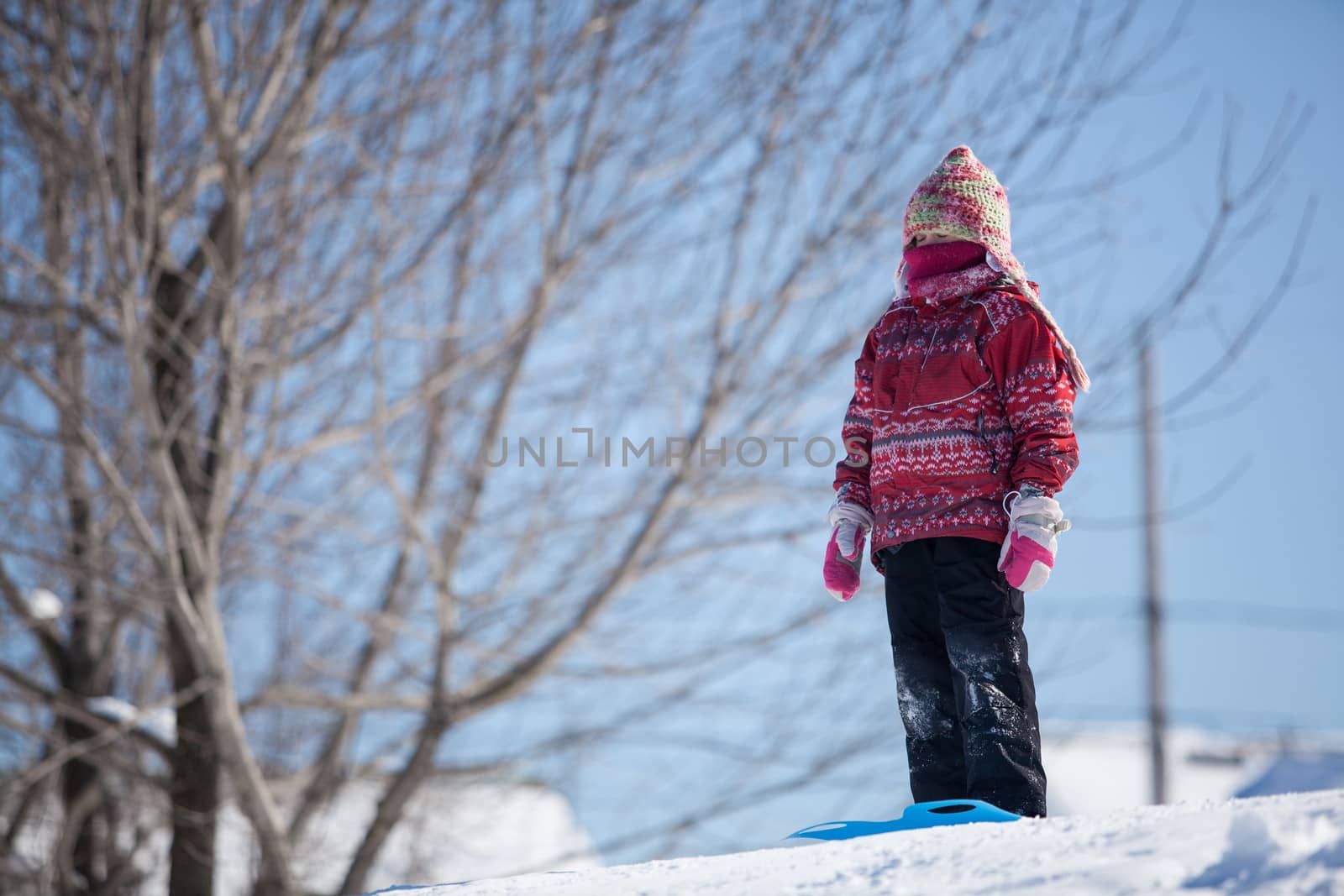 Girl sliding down a hill in the snow