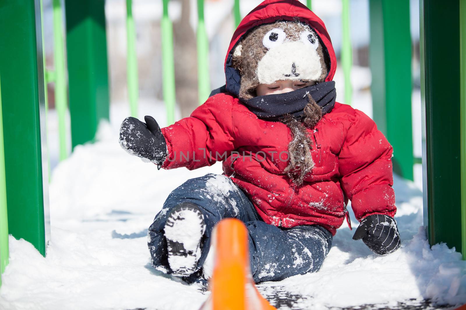 Infant playing in the snow by Talanis