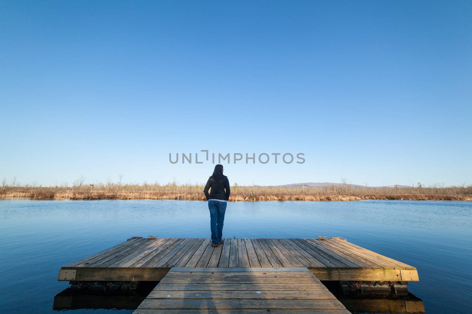 Woman standing near water by Talanis