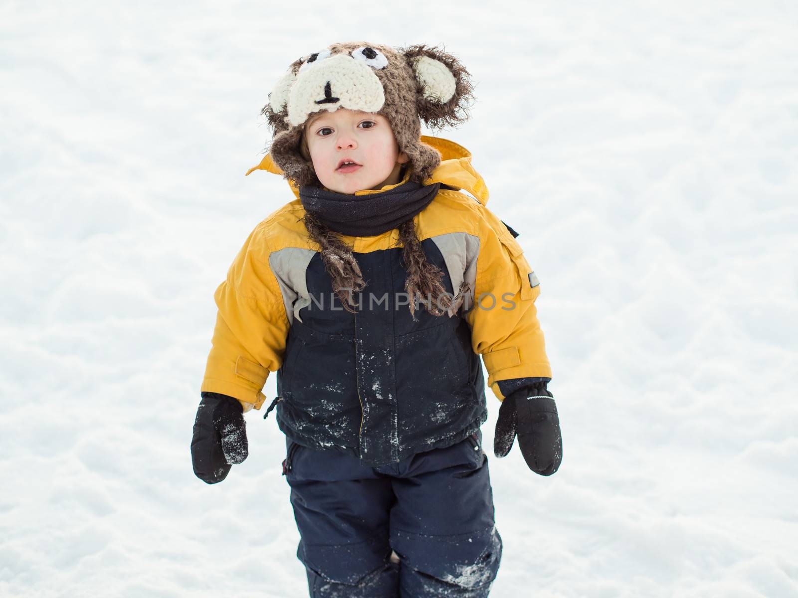 Infant boy playing in the snow