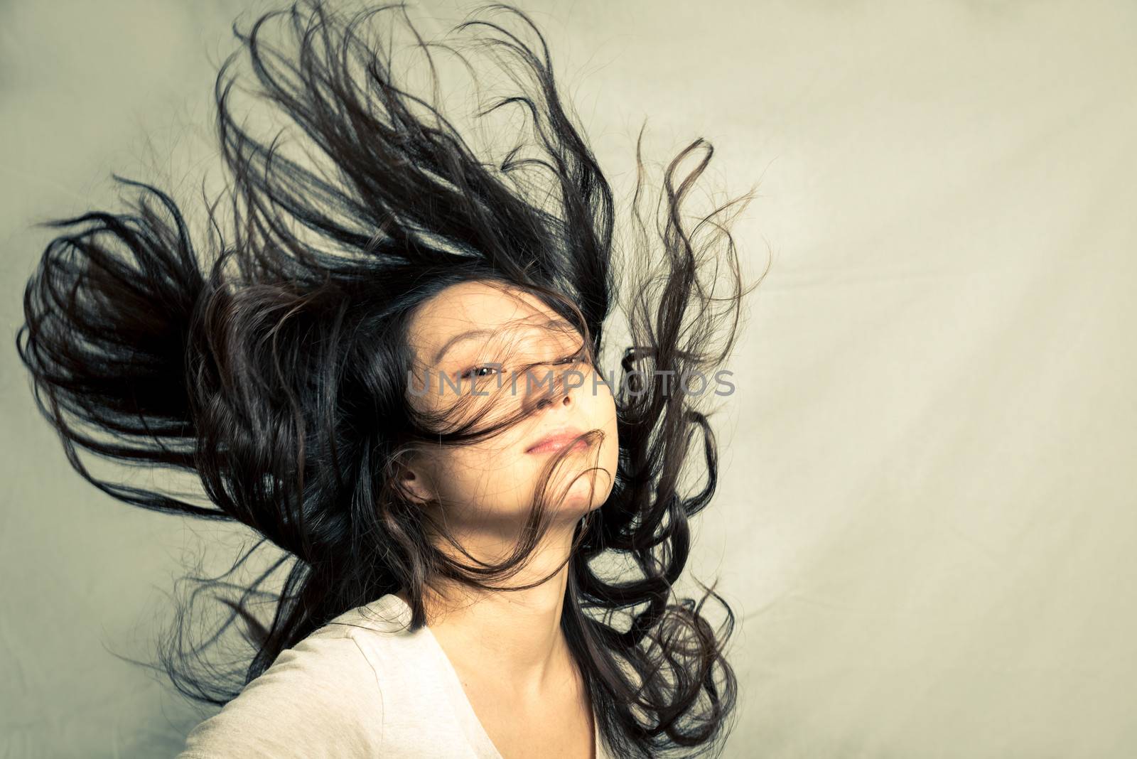 Woman flicking her hair by IVYPHOTOS