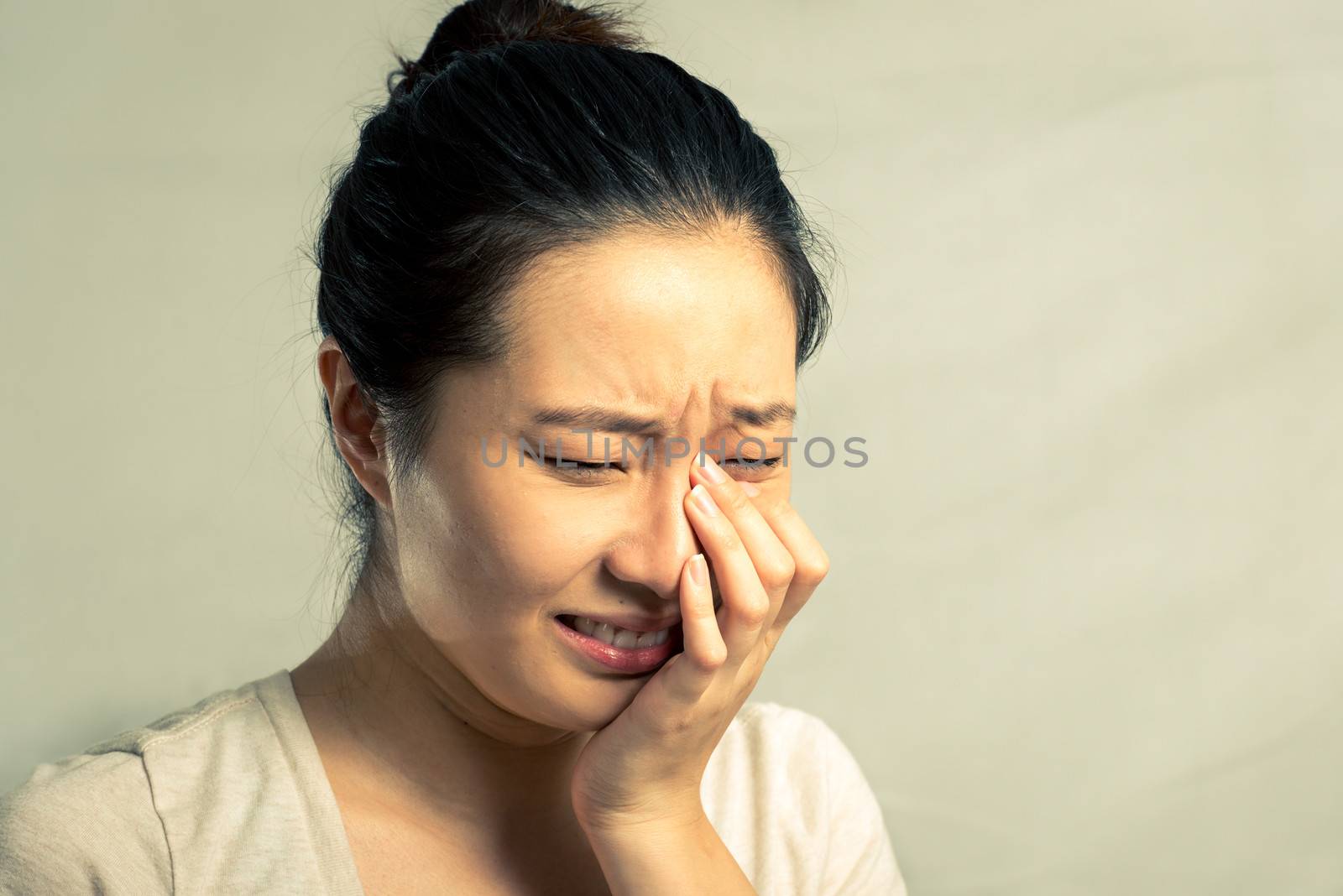 Portrait of woman crying by IVYPHOTOS