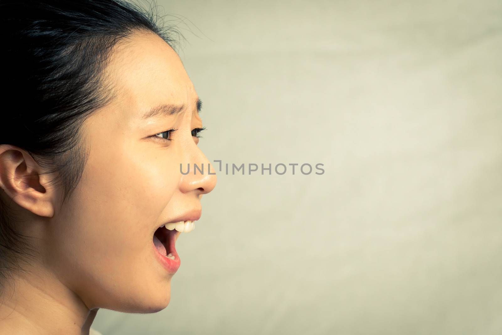 Young woman shouting, with fashion tone and background