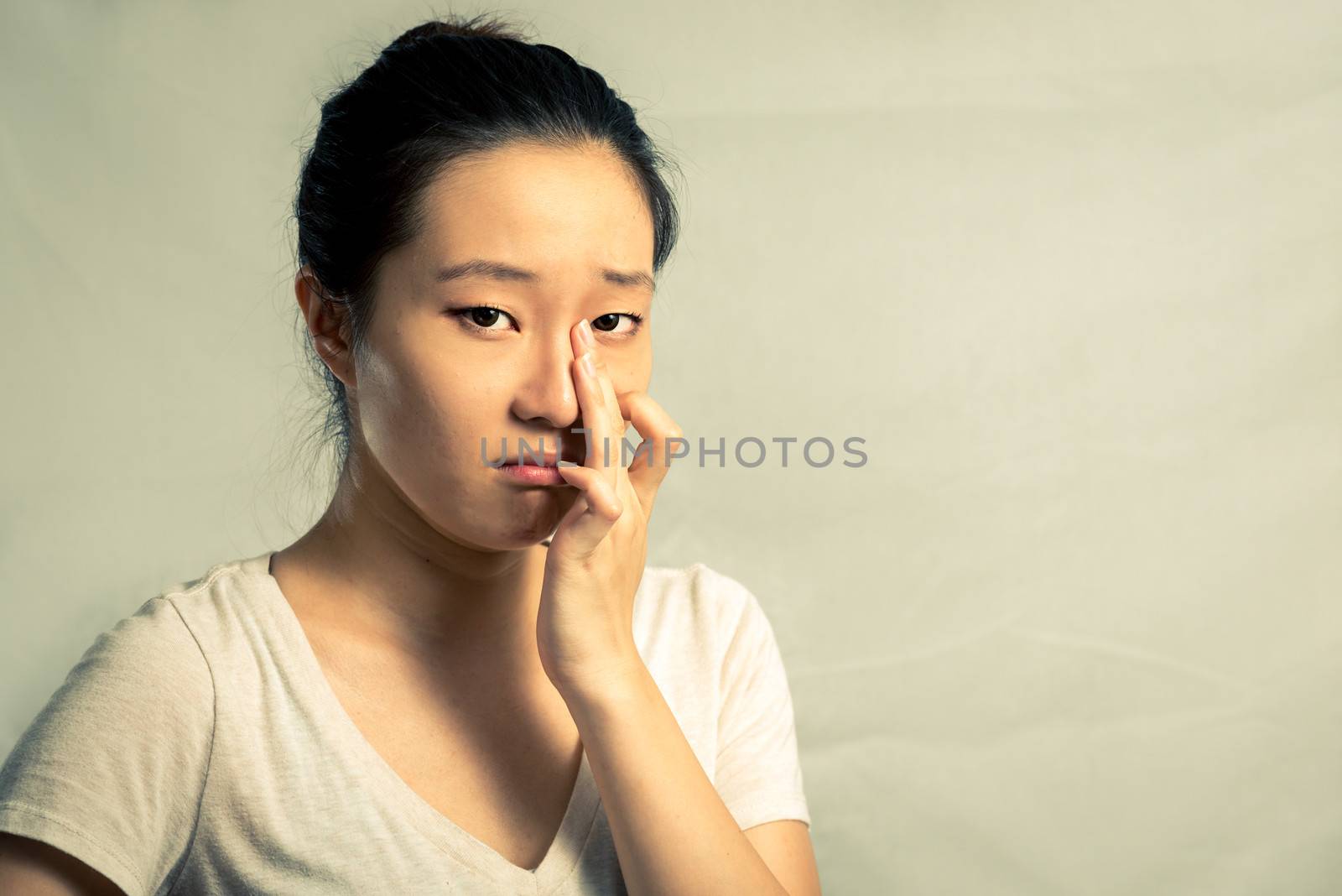Portrait of woman crying by IVYPHOTOS