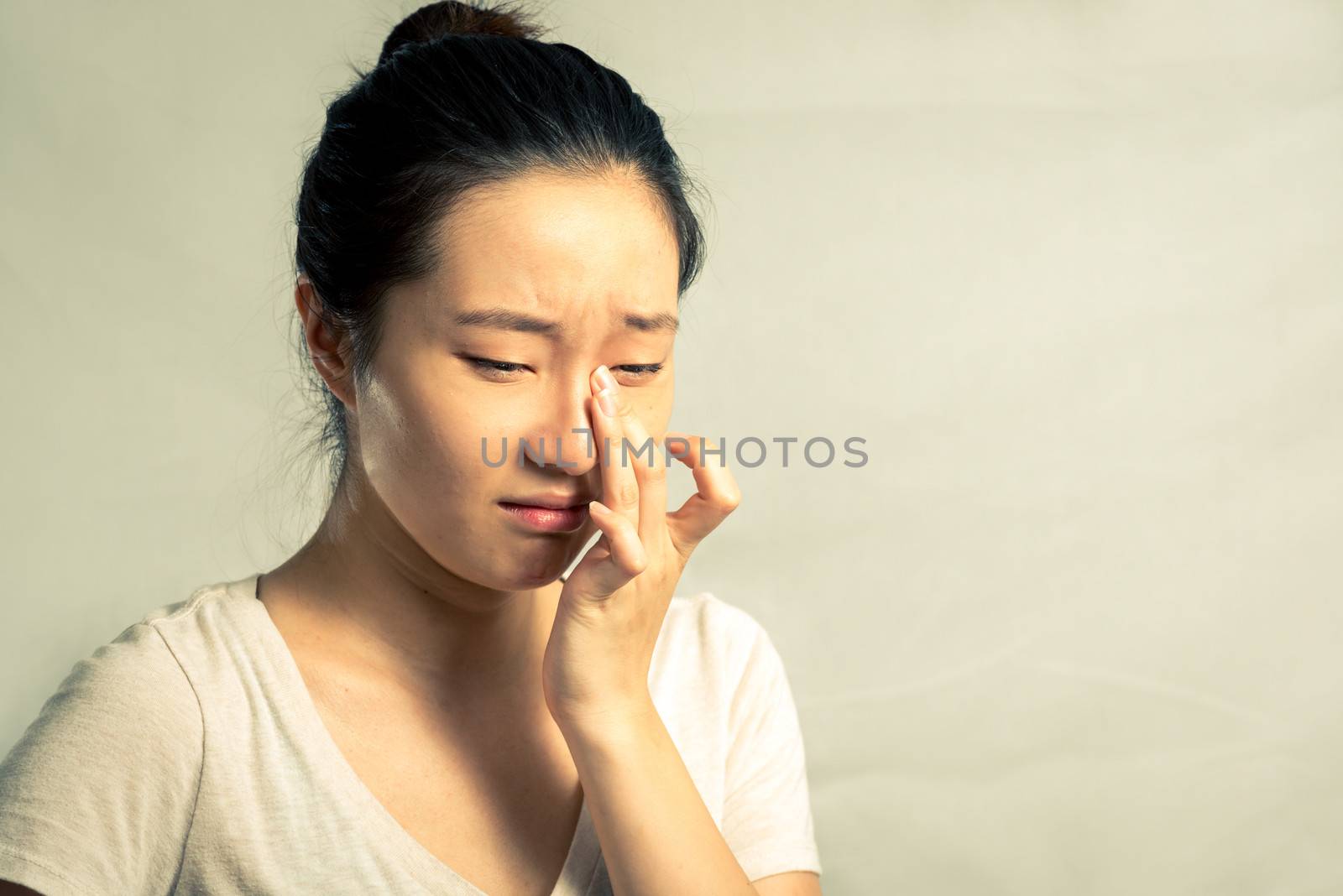 Portrait of young woman crying desperately, with fashion tone and background