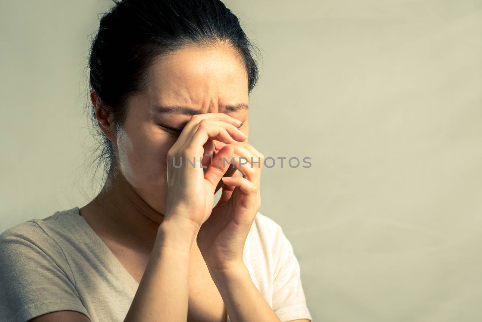 Portrait of young woman crying desperately, with fashion tone and background