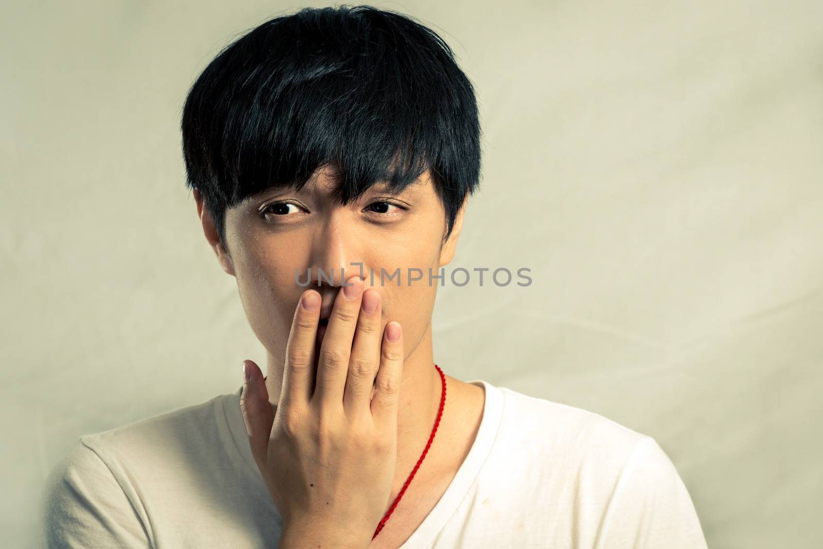 Portrait of shy young man by IVYPHOTOS