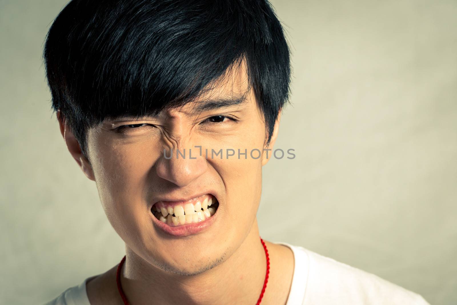 Young man looking angry and yelling, with fashion tone and background