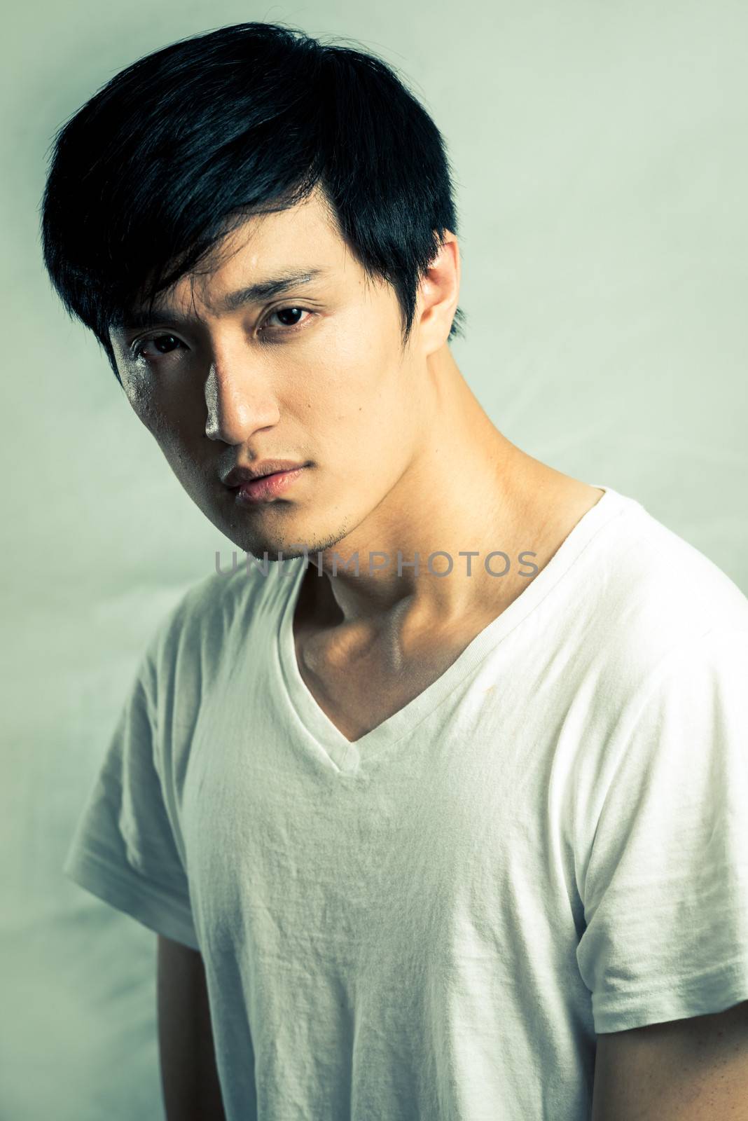 Young male model posing for fashion shot, with fashion tone and background