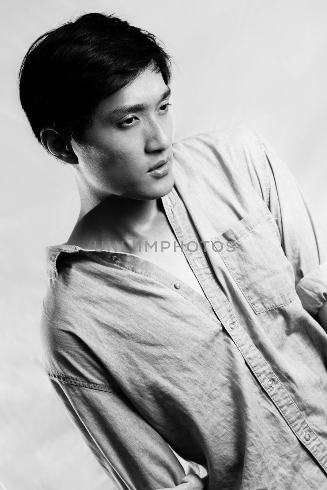 Fashion pose by a young male model, with black and white color and background