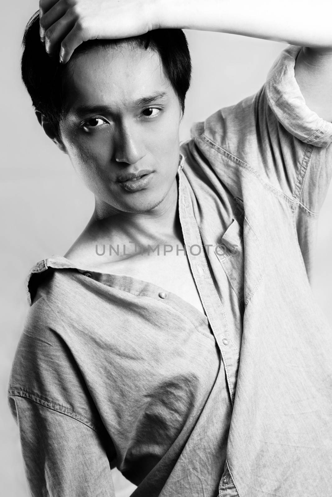 Fashion pose by a young male model, with black and white color and background