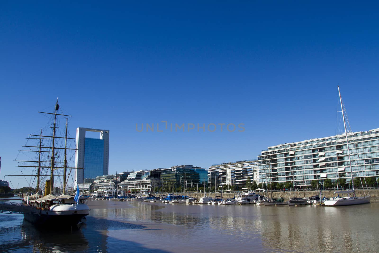 Office buildings and sailboats in harbor of Puerto Madero in Buenos Aires.