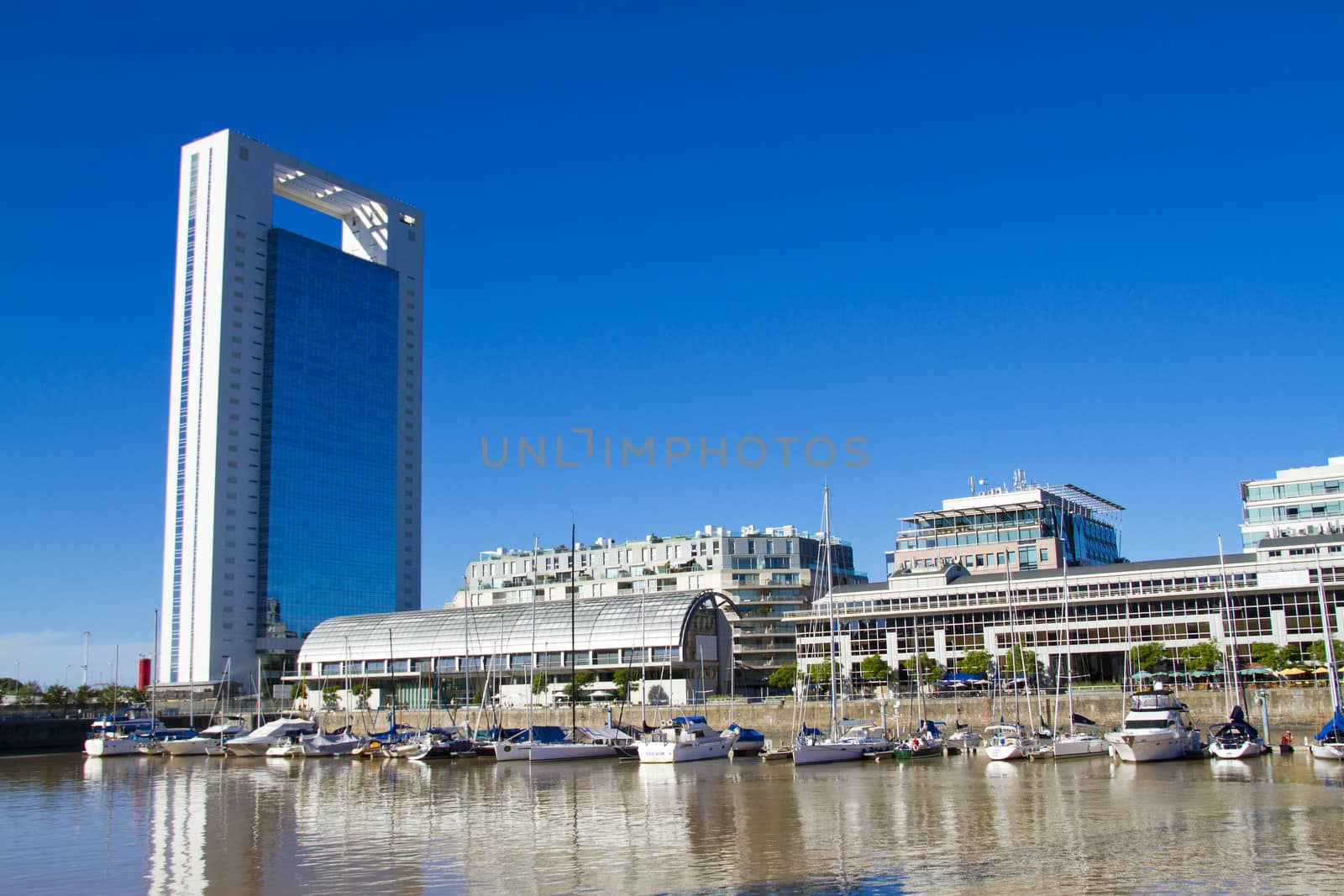 Office buildings and sailboats in harbor of Puerto Madero in Buenos Aires.