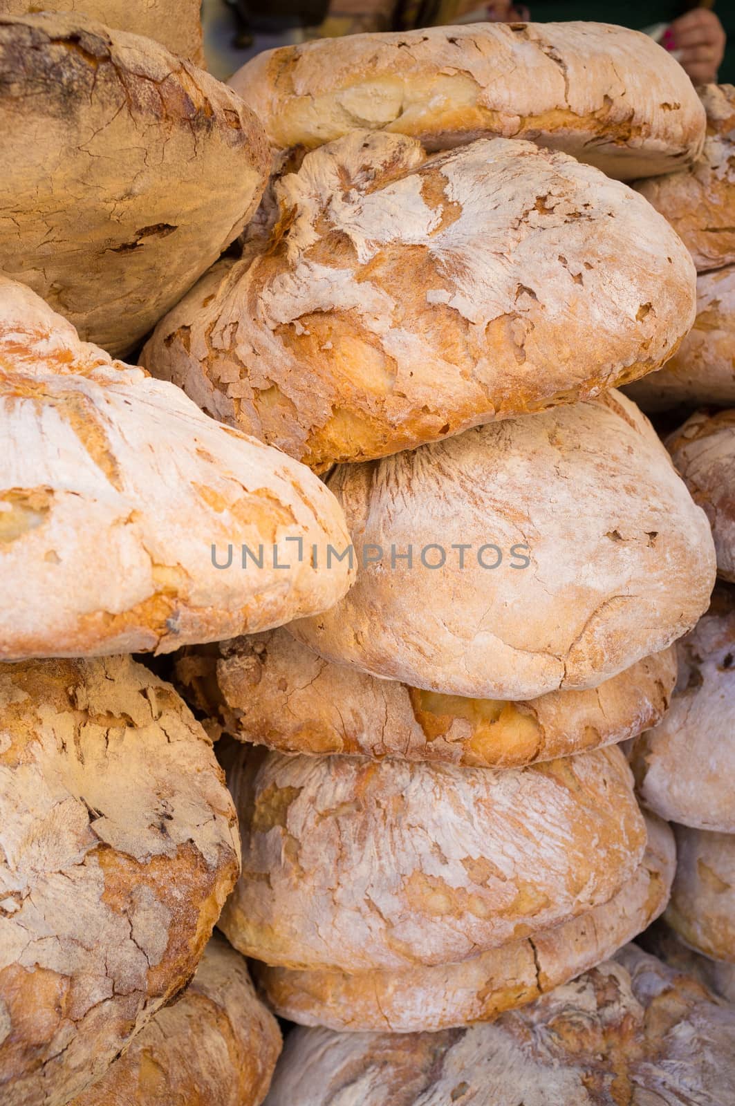 A pile of freshly baked bread on a market stall