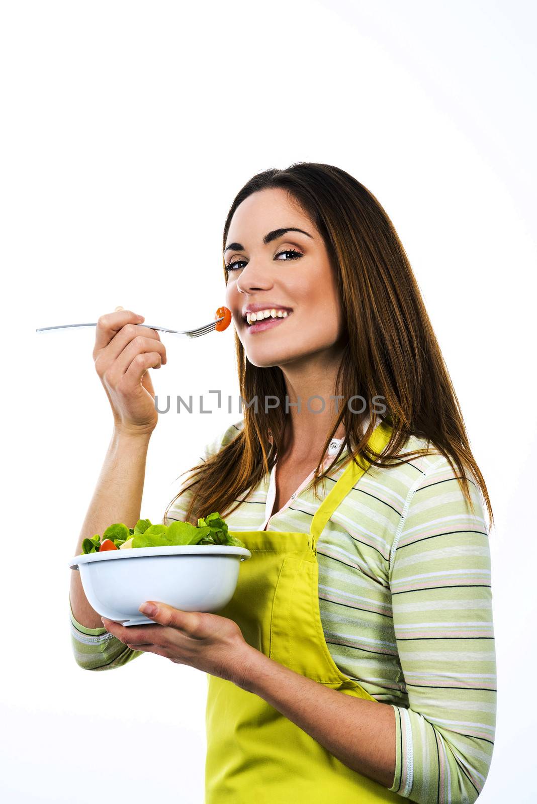 Young Woman Cooking and eating healthy Food - Vegetable Salad. Diet. Dieting Concept. Healthy Lifestyle. Cooking At Home. Prepare Food 