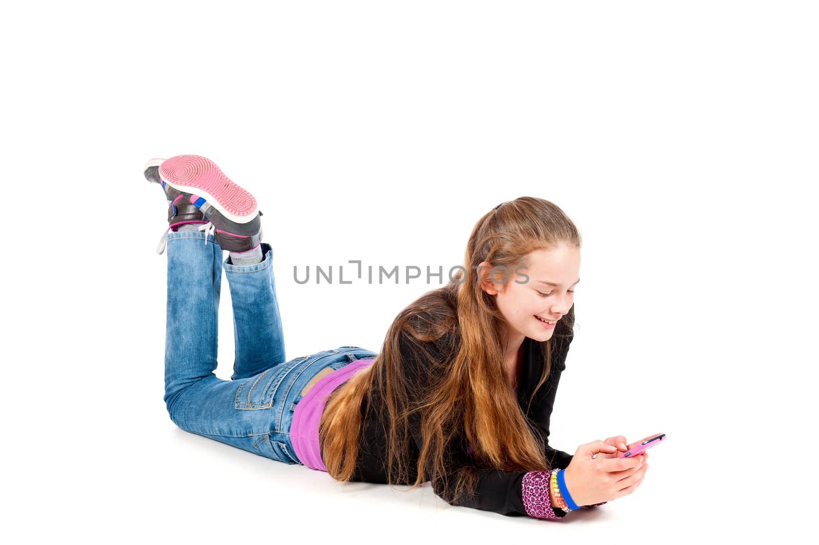 a beautiful young and modern girl, just chilling with her mobile phone on a white background