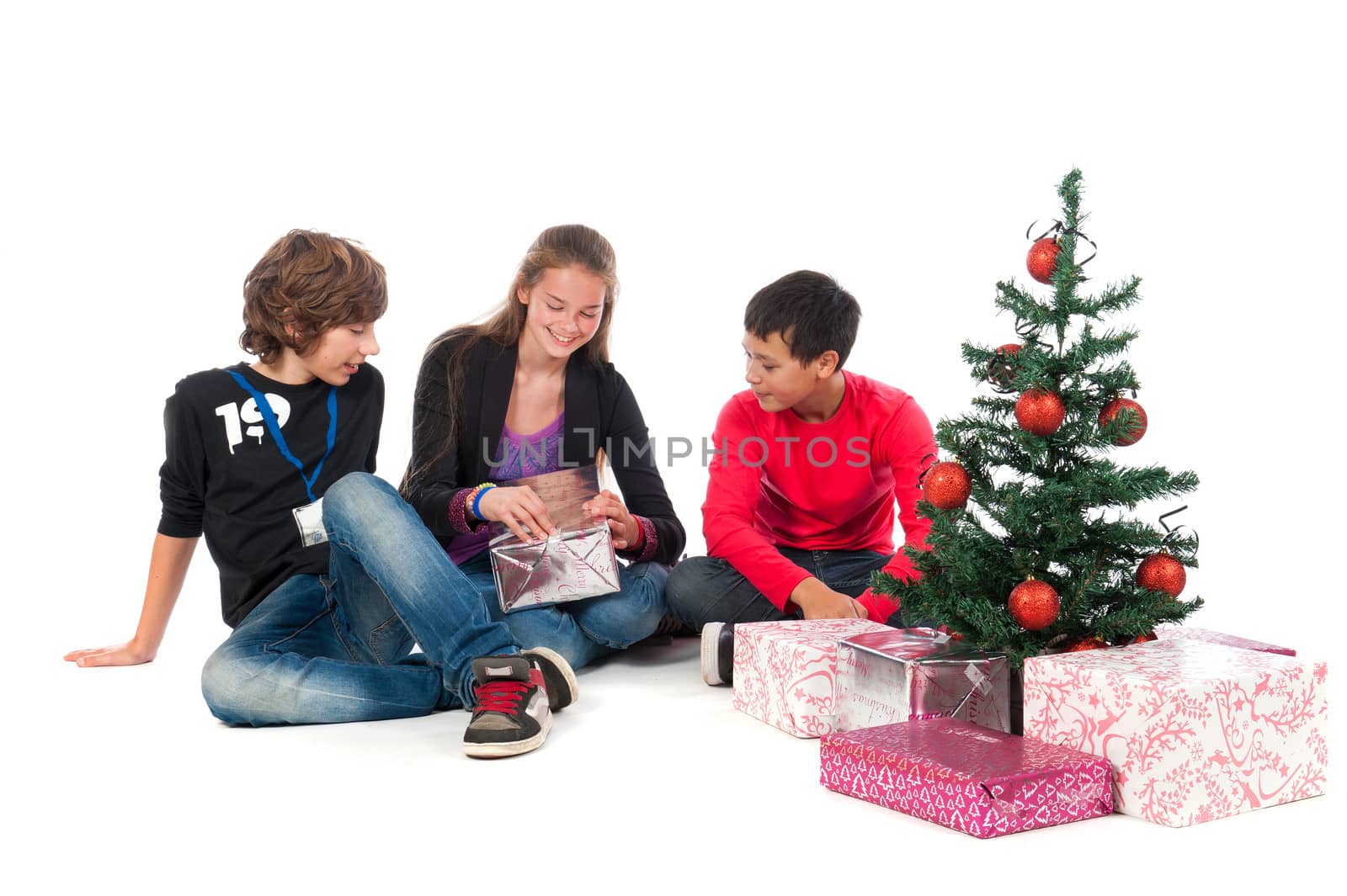 Two boys and a girl, celebrating Christmas on a white background
