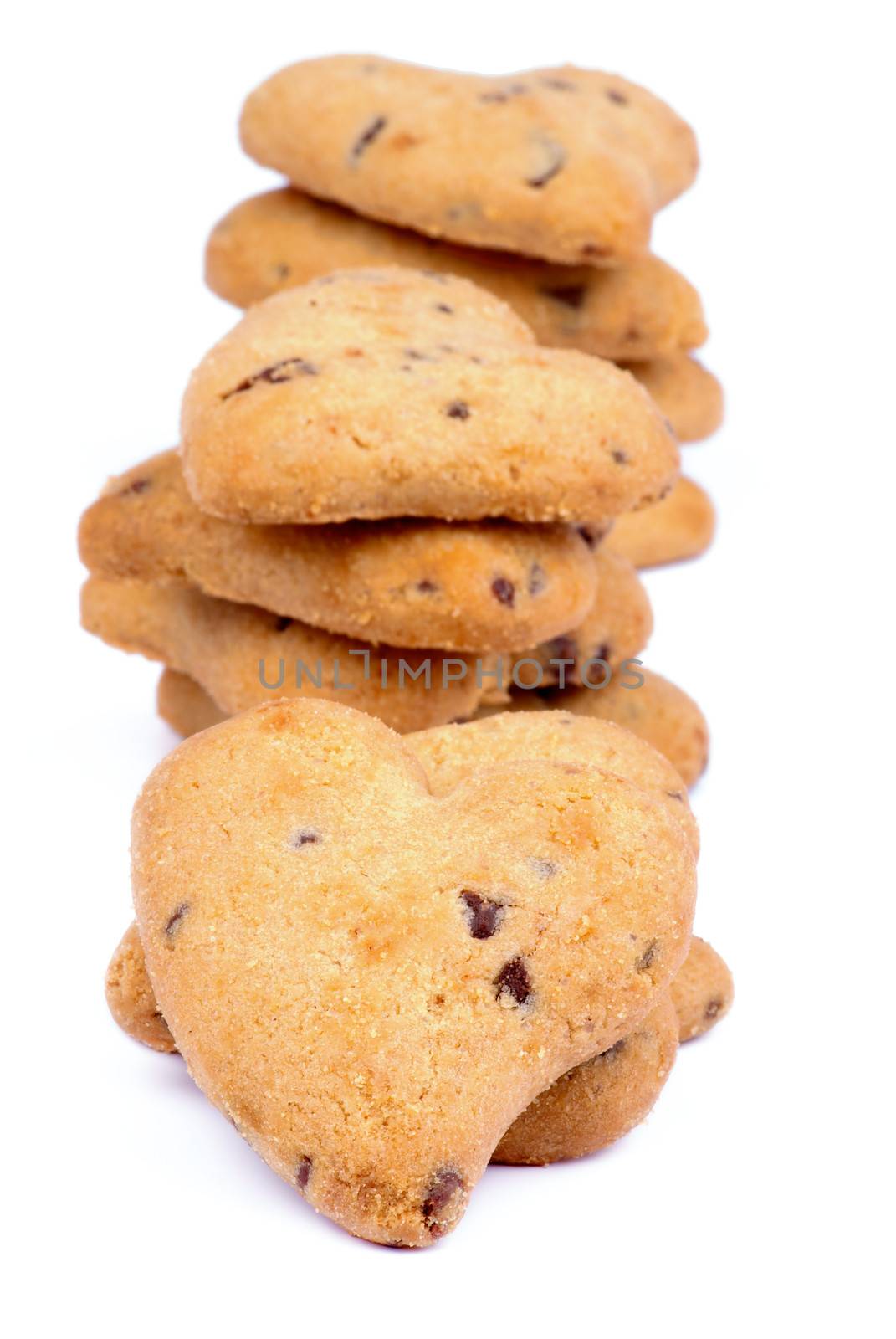 Heap of Valentine Cookies Shaped Heart with Raisins isolated on white background