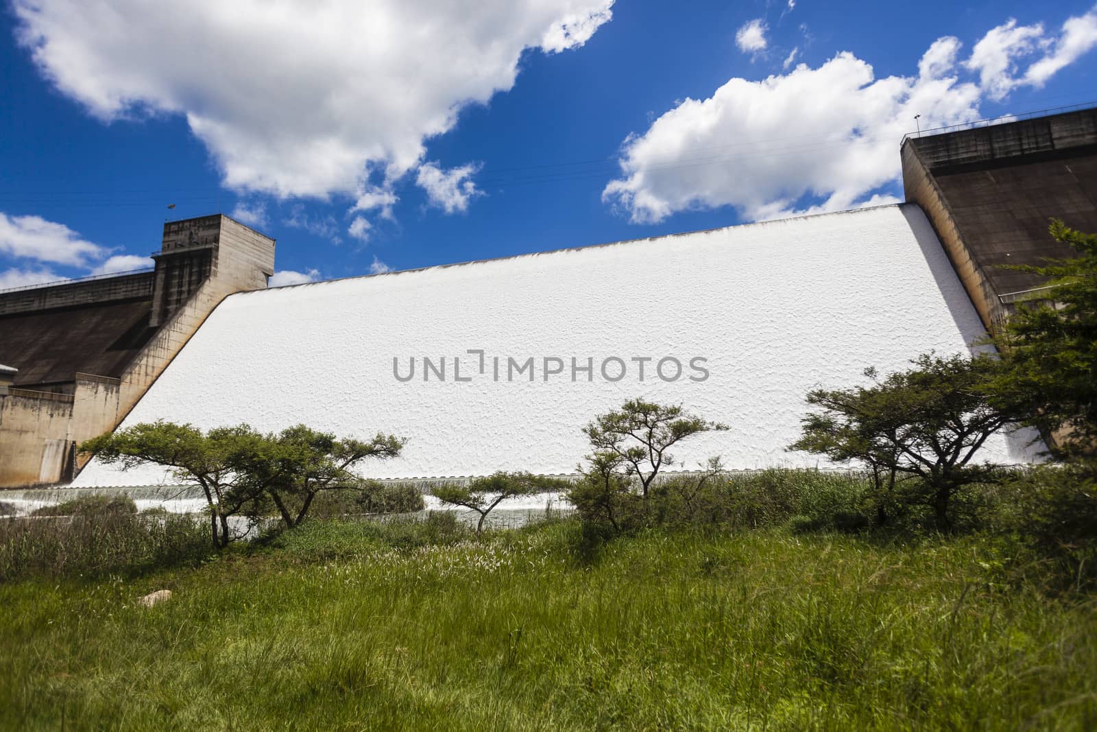 Inanda Dam fill to capacity and water flowing fast in volume over the high wall.