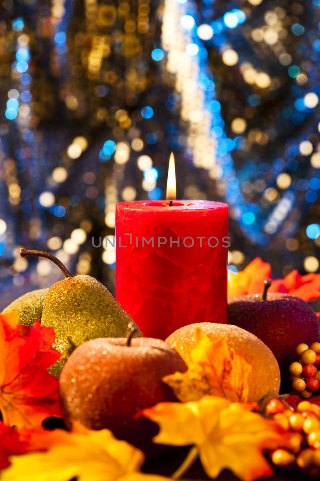 Candles in nice and beautiful colorful autumn leaves