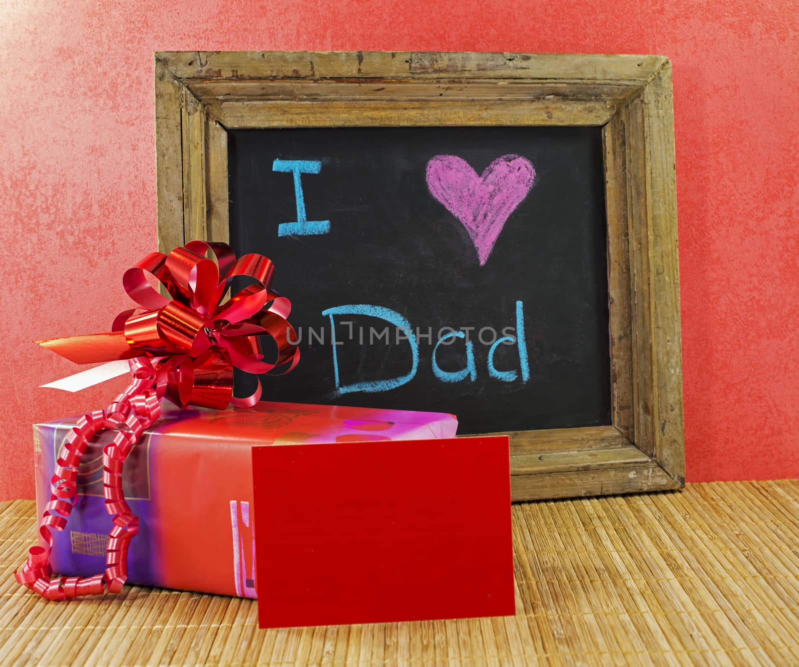 happy fathers day with present and blackboard with text i love dad