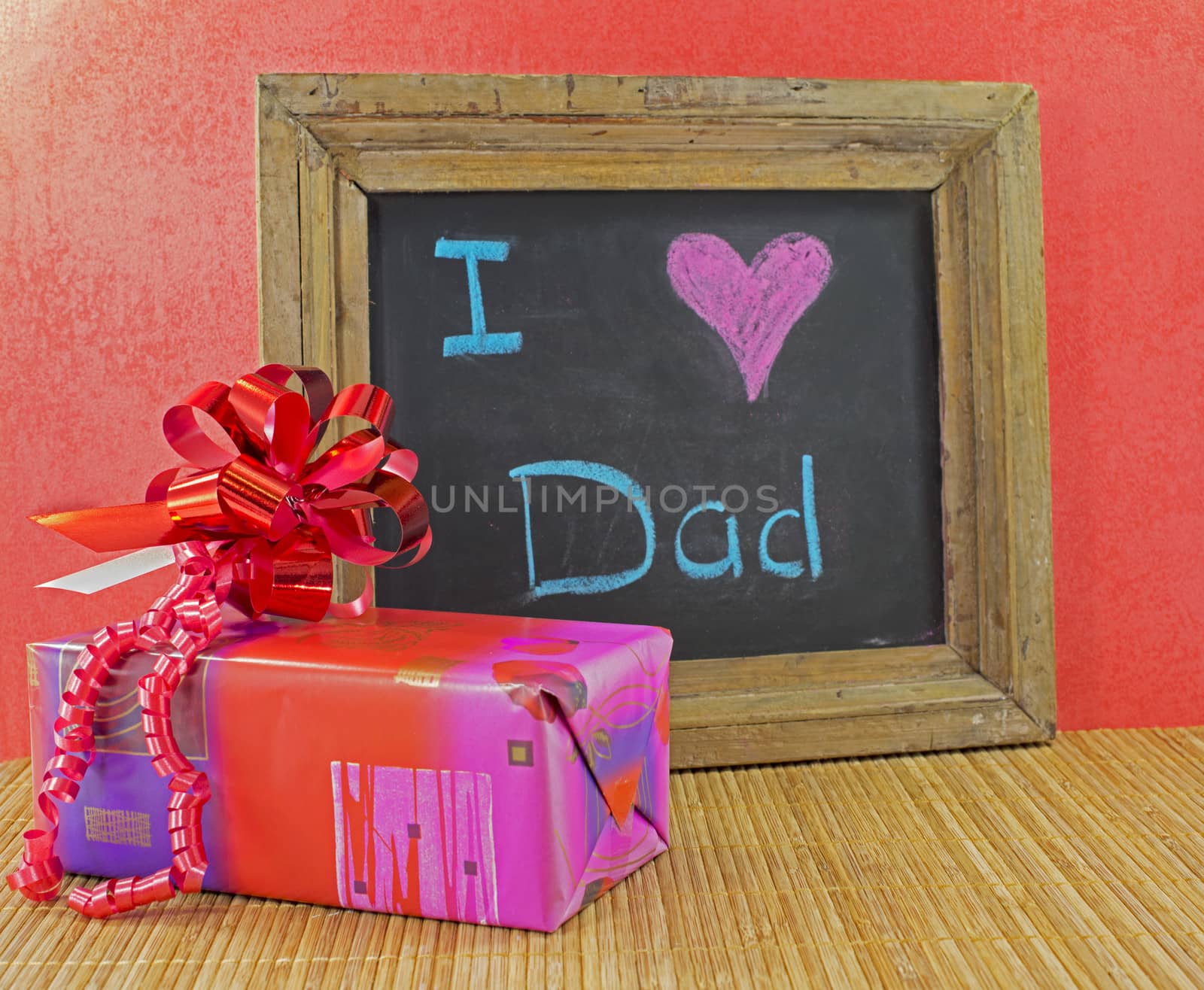 happy fathers day with present and blackboard with text i love dad