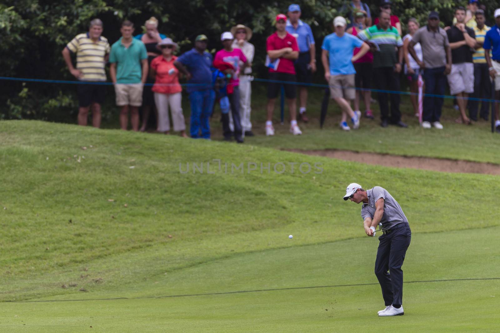 Professionals playing the Volvo Golf championship at Durban Country Club South Africa. Close up telephoto action of players striking ball.