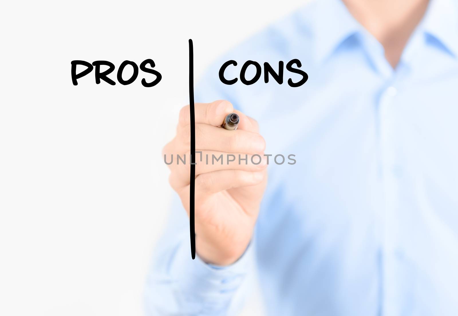 Young businessman holding  a marker and writing pros and cons comparison concept for weigh all arguments. Isolated on white background.