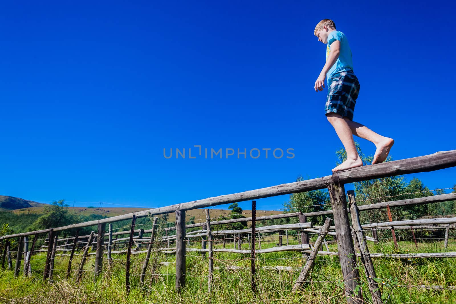 Teenager Balancing Walking Fence by ChrisVanLennepPhoto