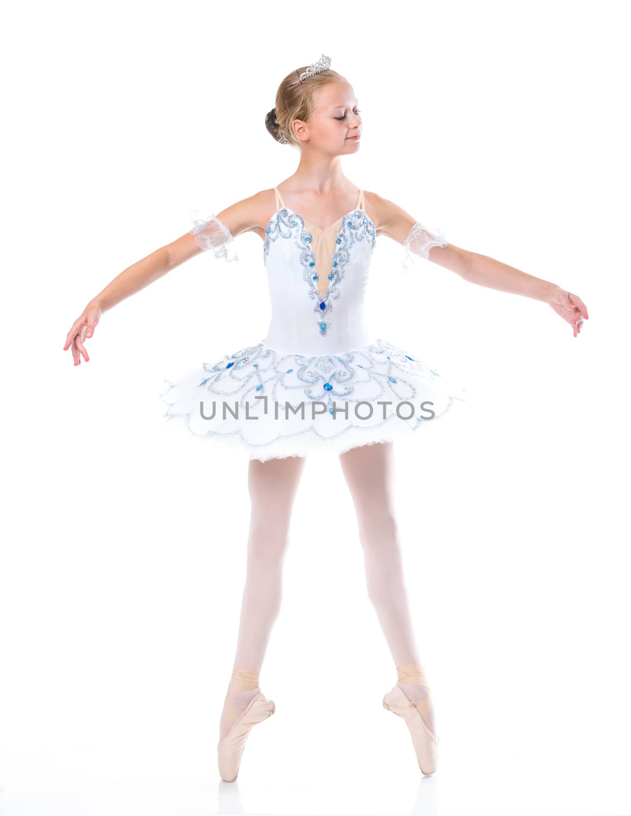 Beautiful young ballerina in classical tutu on a white background